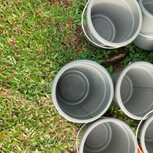 plastic buckets used to transport water from springs