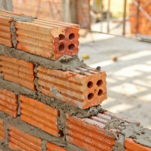 Red brick wall creating with cement mortar